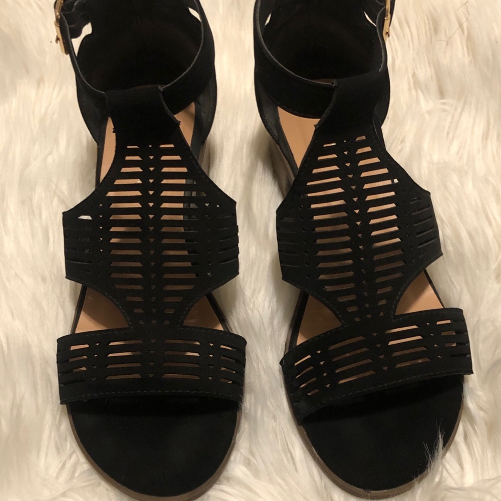 Black strappy sandals with a little heel.